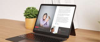 Photo of a tablet on a desk displaying a digital issue of York University’s magazine, featuring an article layout with a portrait of a person holding a bird alongside text.