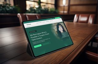 Photo of a tablet on a conference table displaying the Optilogic website homepage with a modern and intuitive design.