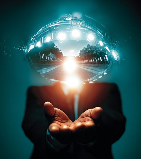 Abstract surreal artwork of a person in a suit holding glowing light in their hands, with a reflective sphere above showing a futuristic landscape—symbolizing AI and advanced technology in the palm of your hand.